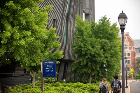 building exterior with YH sign and students walking